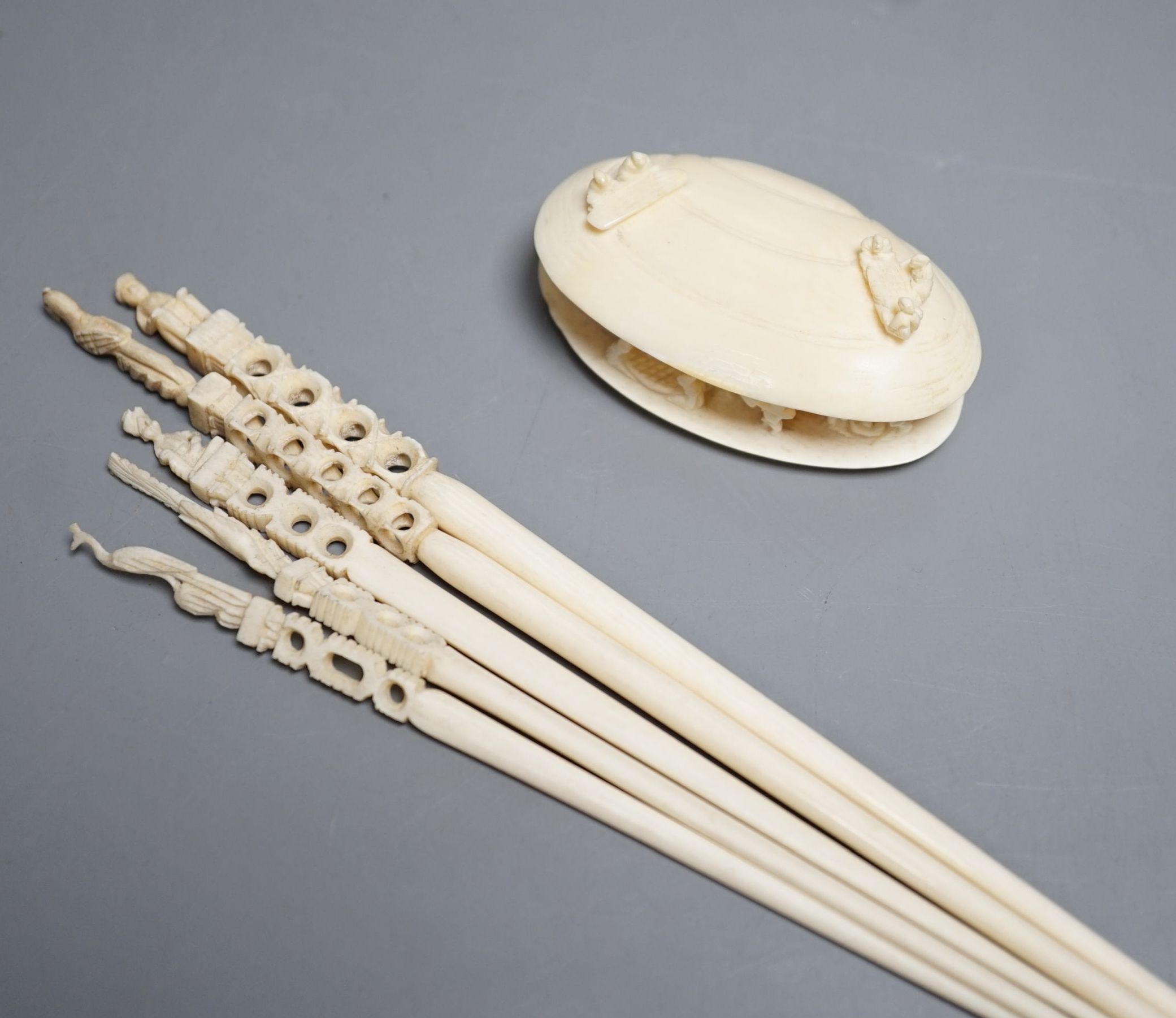 A Japanese ivory model of the clam's dream and five Indian ivory crochet hooks, late 19th/early 20th century